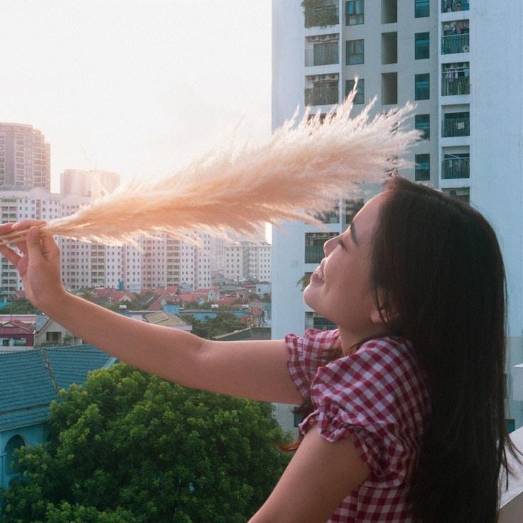Kaveri Mehta, Lead Design Curator at Ever Light Growth Network, reviewing corporate floral arrangements
